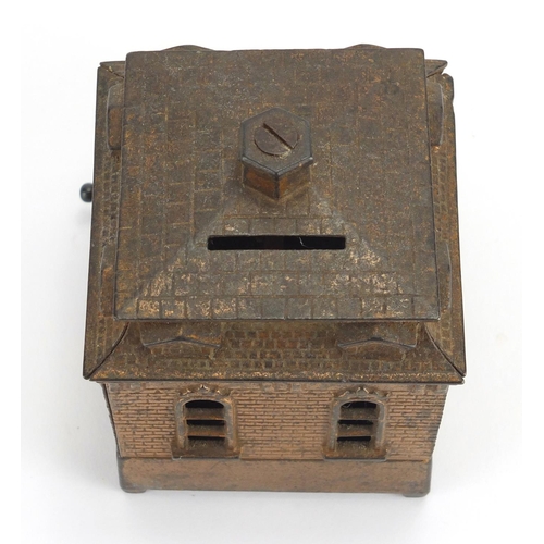 327 - Novelty cast iron money box in the form of a dog rotating in and out of a house, 14cm in length