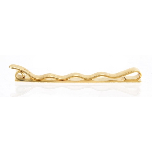 714 - 18ct gold Cartier tie slide, numbered L8766, 6cm in length, approximate weight 9.0g