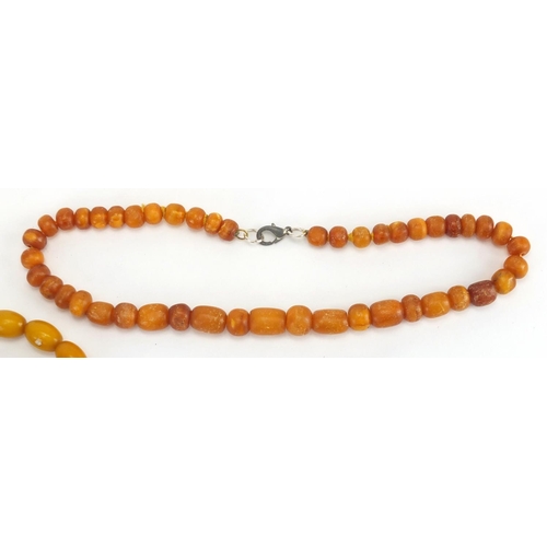 779 - Two amber coloured bead necklaces and a bracelet, the largest 70cm in length, approximate weight 99.... 