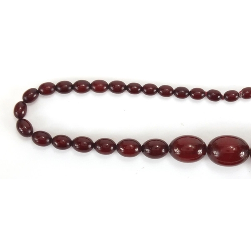 787 - Cherry amber coloured bead necklace and bracelet, the necklace, 60cm in length, approximate weight 5... 