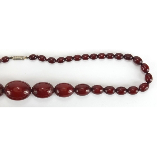 787 - Cherry amber coloured bead necklace and bracelet, the necklace, 60cm in length, approximate weight 5... 