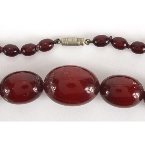 787 - Cherry amber coloured bead necklace and bracelet, the necklace, 60cm in length, approximate weight 5... 