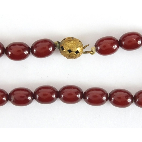 787 - Cherry amber coloured bead necklace and bracelet, the necklace, 60cm in length, approximate weight 5... 