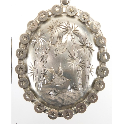 762 - Victorian silver locket engraved with flowers and birds and one other, the largest 5.5cm in length, ... 