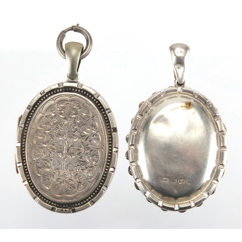 762 - Victorian silver locket engraved with flowers and birds and one other, the largest 5.5cm in length, ... 