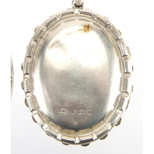 762 - Victorian silver locket engraved with flowers and birds and one other, the largest 5.5cm in length, ... 