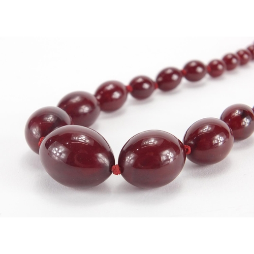 786 - Cherry amber coloured bead necklace, 70cm in length, approximate weight 60.0g