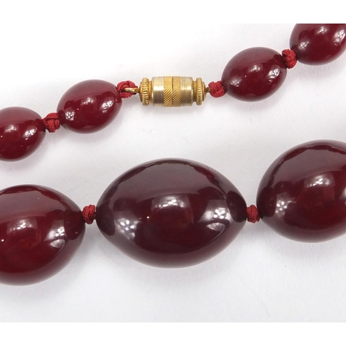 786 - Cherry amber coloured bead necklace, 70cm in length, approximate weight 60.0g