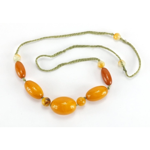 780 - Butterscotch amber coloured bead necklace, the largest bead 3cm in length,  approximate weight 34.0g