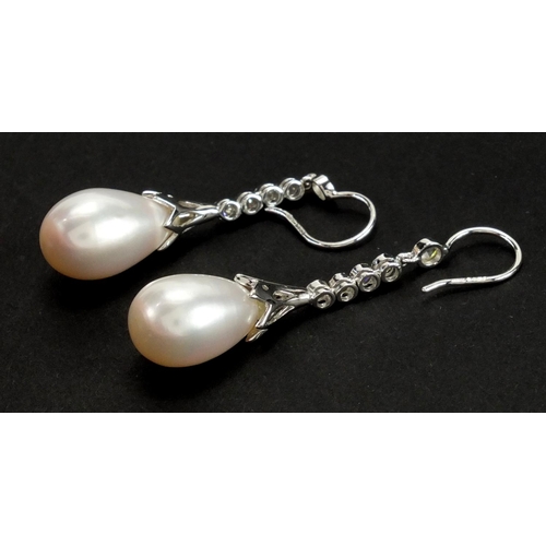 680 - Pair of 18ct white gold Pearl drop and Diamond earrings, 5cm in length, approximate weight 8.6g