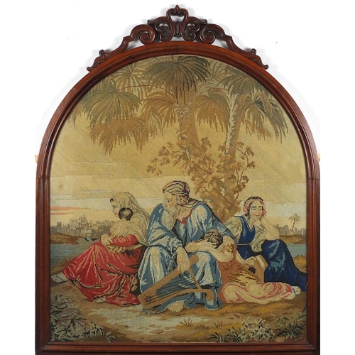 84 - 19th century needlepoint depicting figures surrounding a tree, housed in a carved rosewood frame, ov... 