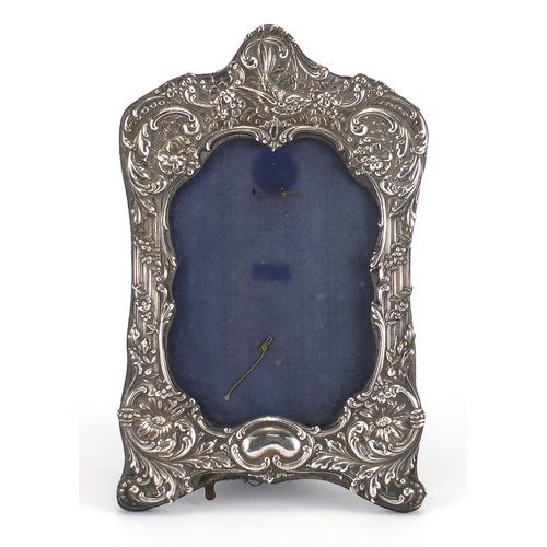 653 - Victorian silver easel photo frame, embossed with a bird and flowers, Chester 1899, 21cm high