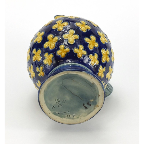 576 - Minton's Majolica jug with mask spout hand painted with flowers, impressed factory marks and numbere... 