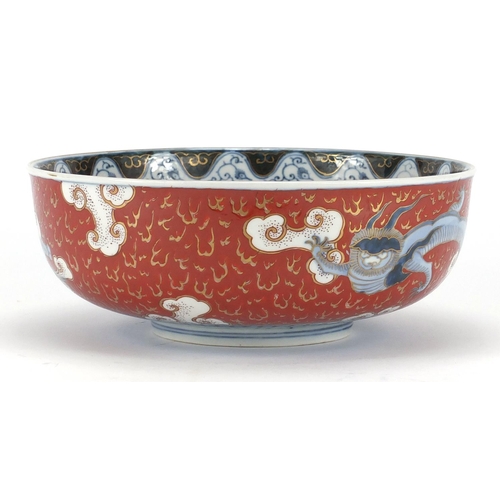 388 - Japanese Imari porcelain bowl, hand painted with Phoenixes and dragons amongst clouds, character mar... 