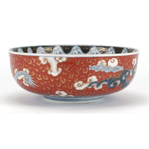 388 - Japanese Imari porcelain bowl, hand painted with Phoenixes and dragons amongst clouds, character mar... 