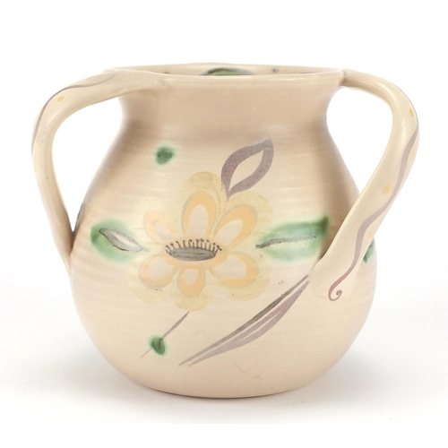 567 - Trial Susie Cooper three handled pottery tyg hand painted with stylised flower heads and leaves, Sus... 