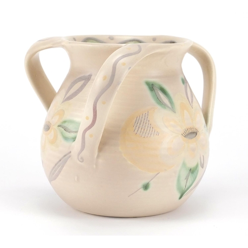 567 - Trial Susie Cooper three handled pottery tyg hand painted with stylised flower heads and leaves, Sus... 