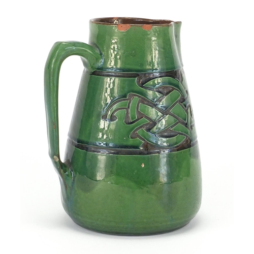 579 - C H Brannam pottery jug made for Liberty & Co, incised with a Celtic design, impressed marks to the ... 