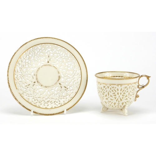 504 - 19th century white reticulated porcelain cup and pierced saucer, each with gilt rims, possibly Worce... 