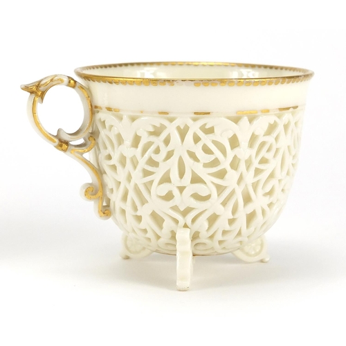 504 - 19th century white reticulated porcelain cup and pierced saucer, each with gilt rims, possibly Worce... 