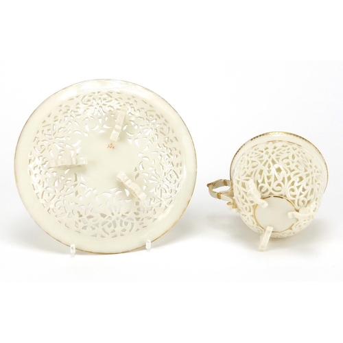 504 - 19th century white reticulated porcelain cup and pierced saucer, each with gilt rims, possibly Worce... 