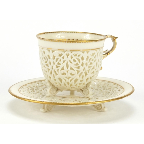 504 - 19th century white reticulated porcelain cup and pierced saucer, each with gilt rims, possibly Worce... 