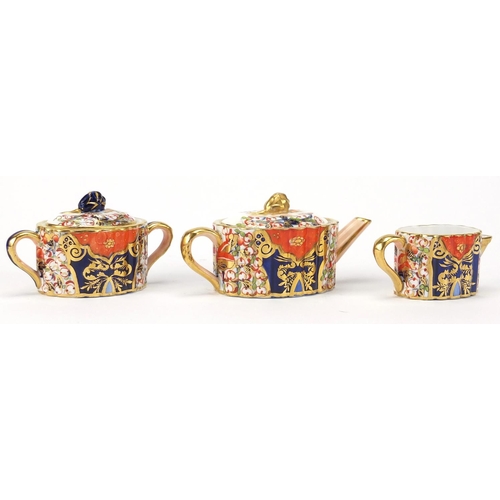 517 - Victorian Davenport miniature three piece tea set, hand painted in the Imari pattern, each with fact... 