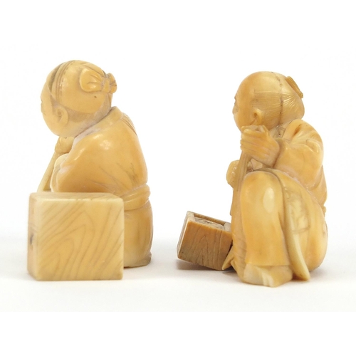 447 - Pair of Japanese carved ivory Okimono's, both of seated workers, each 5cm high