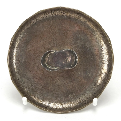 413 - Chinese silver ingot on a dish impressed NK and with character marks, 8.5cm in diameter, approximate... 