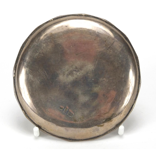 413 - Chinese silver ingot on a dish impressed NK and with character marks, 8.5cm in diameter, approximate... 