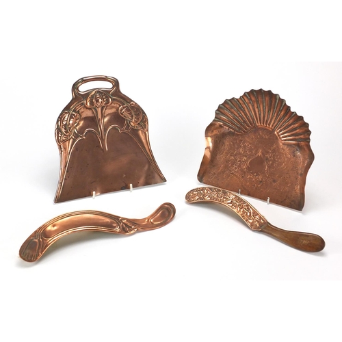 610 - Arts & Crafts copper comprising two hand brushes and two trays, embossed and engraved with stylised ... 