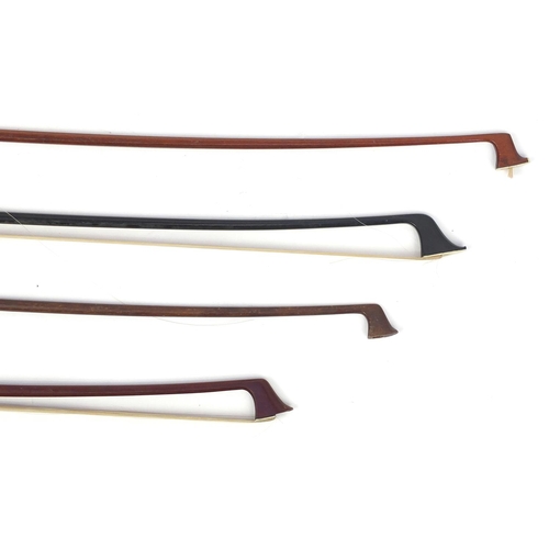 141 - Four old wooden violin bows including an ebonised example each with Mother of Pearl frogs, one indis... 