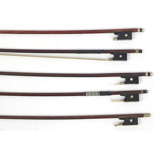 143 - Seven old wooden violin bows, one stamped Germany, the largest 74cm in length