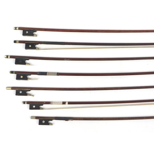 143 - Seven old wooden violin bows, one stamped Germany, the largest 74cm in length