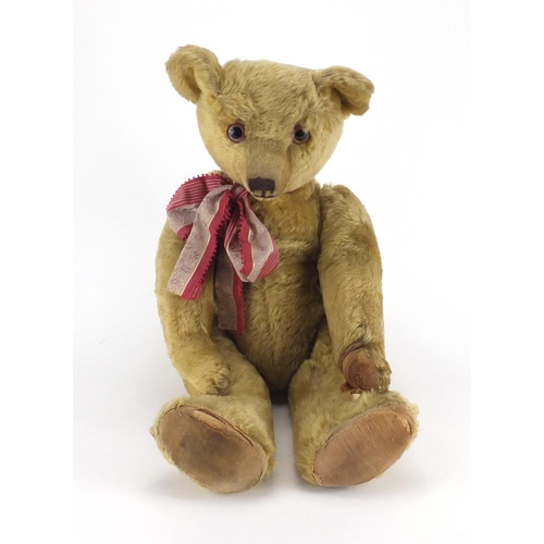 330 - Vintage golden straw filled teddy bear with jointed limbs and beaded glass eyes, 63cm high