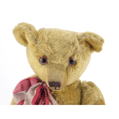 330 - Vintage golden straw filled teddy bear with jointed limbs and beaded glass eyes, 63cm high