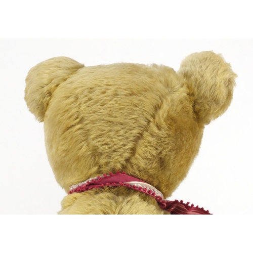 330 - Vintage golden straw filled teddy bear with jointed limbs and beaded glass eyes, 63cm high