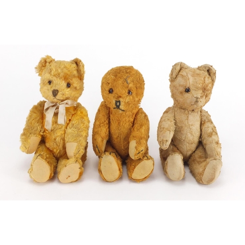 338 - Three vintage golden teddy bear's each with jointed limbs and beaded eyes, the largest 22cm high