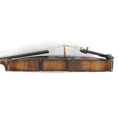 130 - Old wooden violin with one piece back, bow and fitted carrying case, the violin bearing a Renia pape... 