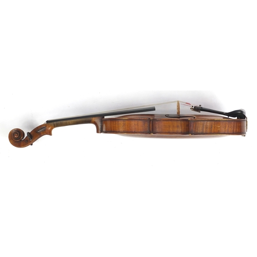 135 - Old wooden violin with scrolled neck, two bows and fitted wooden carrying case, the violin bearing a... 