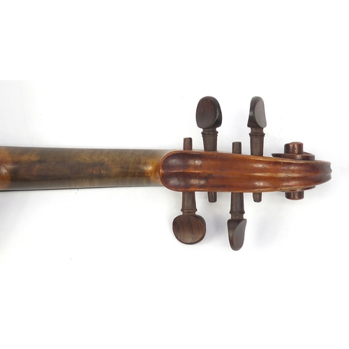 135 - Old wooden violin with scrolled neck, two bows and fitted wooden carrying case, the violin bearing a... 