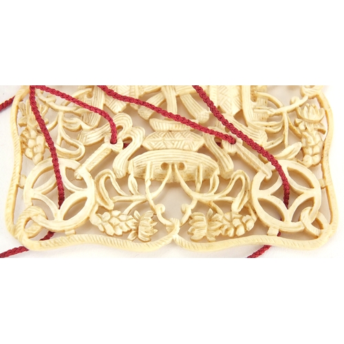 439 - Chinese Canton ivory pierced hanging panel, finely carved with objects and flowers, 7cm x 6.5cm