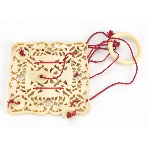 439 - Chinese Canton ivory pierced hanging panel, finely carved with objects and flowers, 7cm x 6.5cm