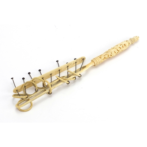 441 - Chinese Canton ivory puzzle, the handle carved with dragons amongst clouds, 26cm in length