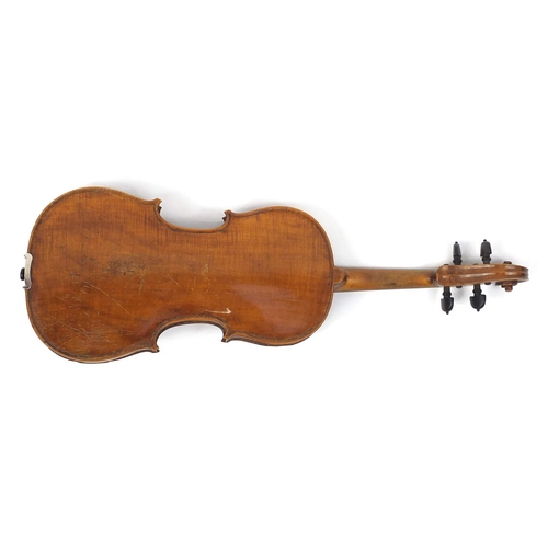 134 - Old wooden violin with one piece back and scrolled neck, together with two unnamed violin bows and f... 