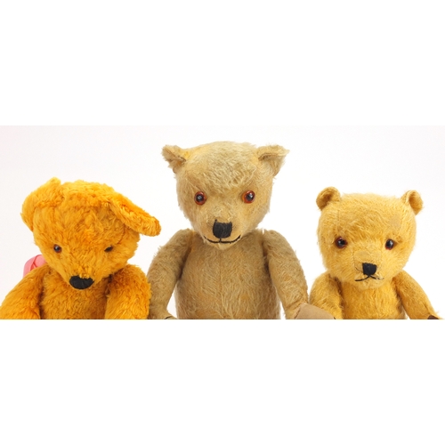 336 - Three vintage teddy bear's including a straw filled example, all with jointed limbs and beaded eyes,... 