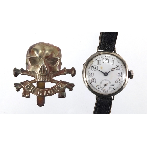 282 - Military interest silver cased trench watch with enamelled dial and Roman numerals with cap badge