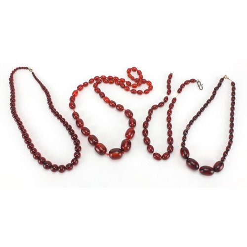 791 - Four cherry amber coloured bead necklaces, the largest 80cm in length, approximate weight 205.0g