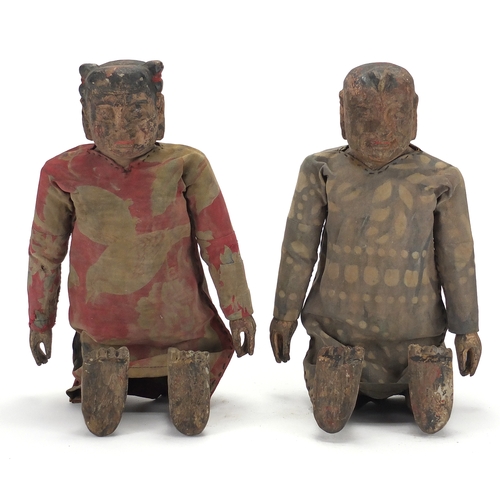 396 - Pair of Chinese lacquered and carved wood puppets, both with cloth dresses, each approximately 39cm ... 