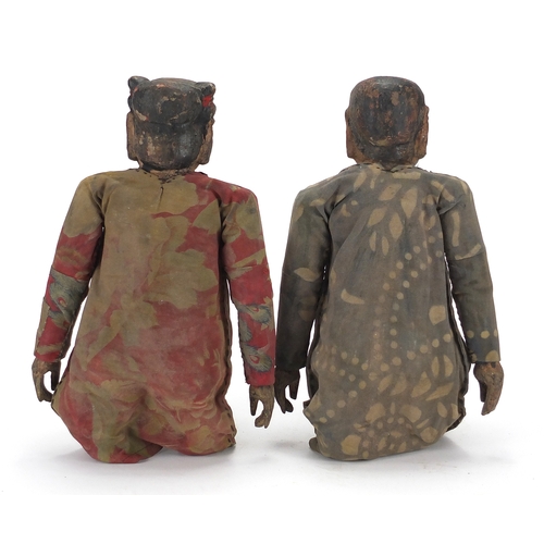 396 - Pair of Chinese lacquered and carved wood puppets, both with cloth dresses, each approximately 39cm ... 